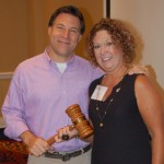 Dave Tabor receives gavel from outgoing President Leisa Fox of the Iowa Association of Business